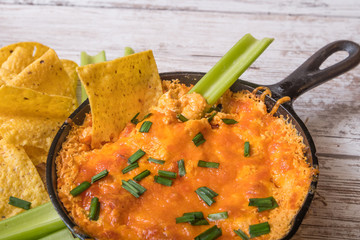 Chicken cheese dip with celery and tortilla chips