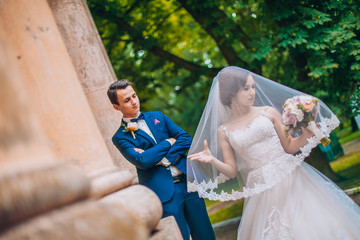 Sensual wedding married couple, valentines hugging in front of old slavic castle. Wedding day of...