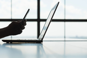 qr codes and safe authorization concept. man scanning laptop screen with mobile phone. technology...