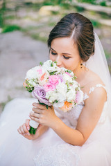 Beautiful bride holding wedding bouquet. Best day for newlyweds couple.