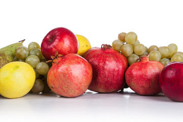 pomegranates and other fruits on a white background