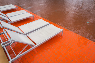 The white swimming pool beds beside orange swimming pool