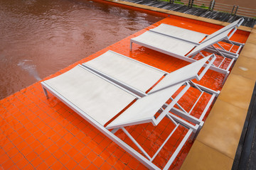 The white swimming pool beds beside orange swimming pool