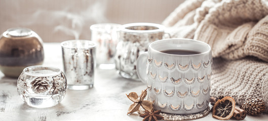 cozy winter composition with a cup and sweater