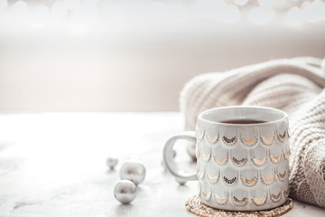 cozy winter composition with a cup and sweater