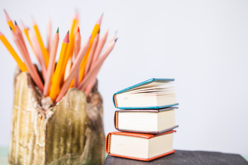 Pile of various books on wooden background