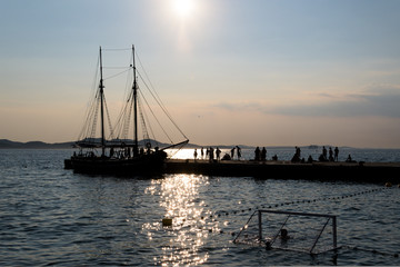 Silhouette of a sail boat and the harbour of Zadar, Croatia