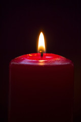 red candle in the dark