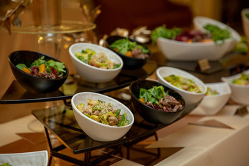 dishes with salad and meat snack at reception.