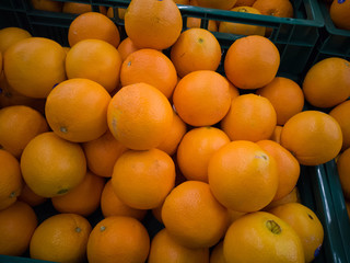 Some oranges in a basket at supermarket.