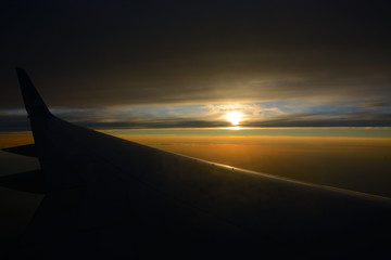 Airplane wing at sunset