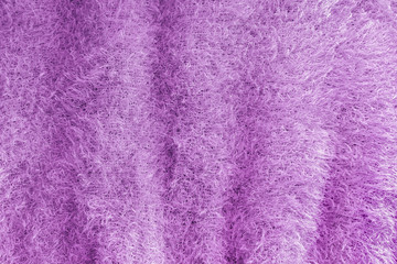 Background of soft, fluffy knit fabric. Lilac knitted texture