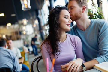 Young happy couple on date in coffee shop