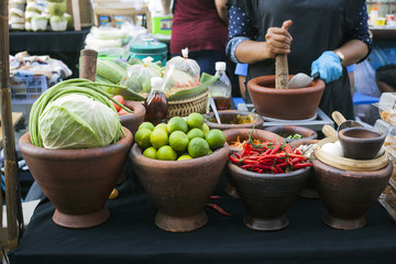 Clay bowls with fresh vegetables cabbage, lime and chili peppers