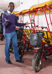 Fototapeta na wymiar African-American young man offering cycle rickshaw service