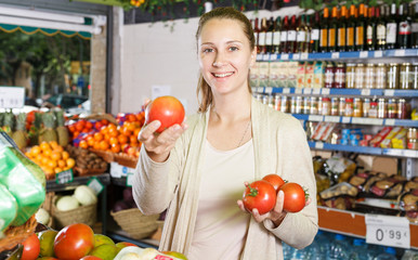 Female is holding tomatos