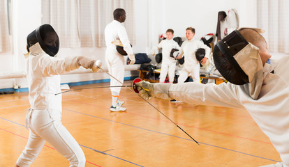 Modern group  practicing fencing techniques