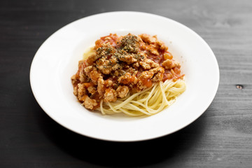 Spaghetti on black wooden background