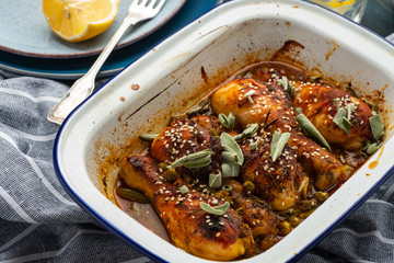 Baked chicken legs with peas, beans and fresh herbs. Chicken drumsticks with tasty sause and greens