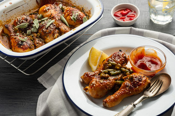 Baked chicken legs with peas, beans and fresh herbs. Chicken drumsticks with tasty sause and greens