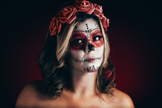 Closeup portrait of Calavera Catrina. Young woman with sugar skull makeup. Dia de los muertos. Day of The Dead. Halloween.