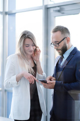 A man and a woman at the entrance to the office door are talking, acquaintance.