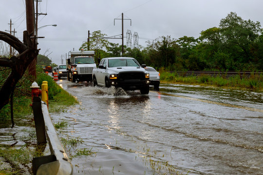 Car traffic in a heavy rain on a flooded road