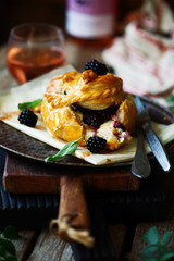 Baked brie with blackberry in puff pastry.style rustic