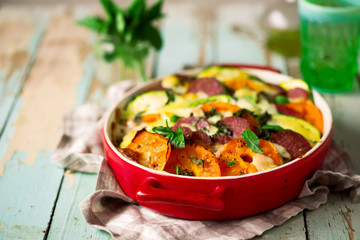 casserole with vegetables and salami .style rustic