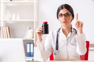 Woman doctor with bottle of medicines