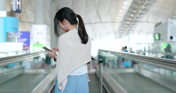 Woman use of mobile phone in the airport
