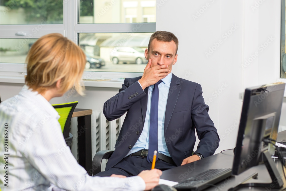 Wall mural do not tell the truth, keep silent. business man covers his mouth with his hand during the interview