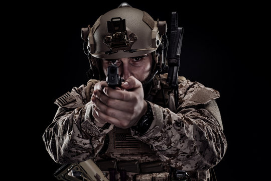 soldier or private military contractor holding rifle. Image on a black background. war, army, weapon, technology and people concept