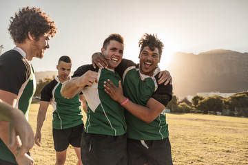 Rugby players celebrating a win - Powered by Adobe