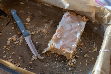 Cake with the addition of tasty ripe apples. The last piece of sweet dessert on a baking tray.