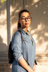 Young attractive bespectacled woman looking at the camera and smiling.