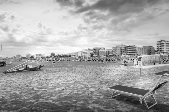 Fototapeta rescue boat in black and white on beach on a bad weather day