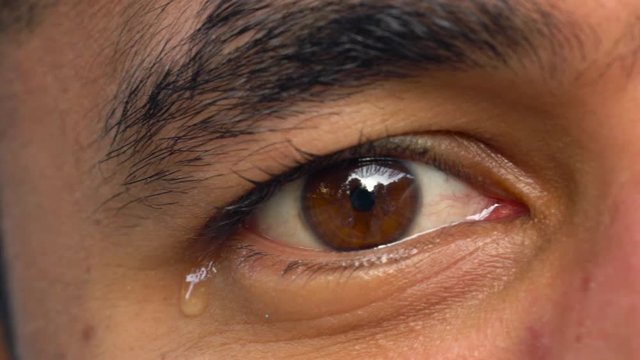 Beautiful eye of a man of Arab nationality close-up. The man is crying