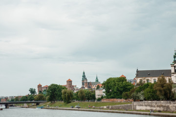 The river flows through the city. Church on the hill above the river. Wisla River in Krakow. Float the boat and the ship under water