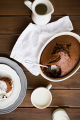 flat lay chocolate cake with cream on wood table