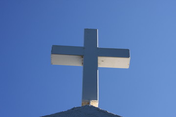 Cycladic greek orthodox church on Paros island, Greece. White cross against blue sky