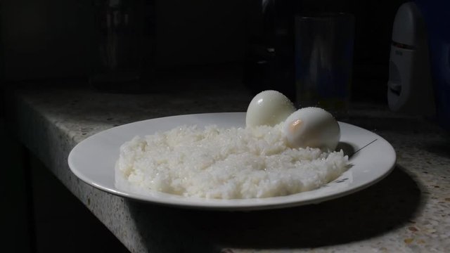 platillo de arroz con huevo cocidos en plato blanco en cocina latina