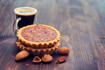 portuguese almond tart on brown wooden background
