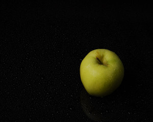 green apple on black background