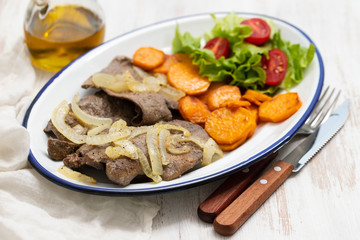 fried liver with onion, sweet potato and salad  on white dish