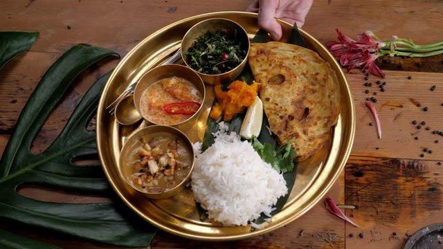 Assorted indian sri-lanka food set on wooden background. Dishes and appetisers of indeed cuisine, rice, lentils, paneer, samosa, spices, masala. Bowls and plates with indian food top view chicken