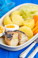 cod fish with boiled egg and vegetables on dish