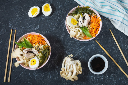 Miso Ramen Asian noodles in bowls on dark stone background