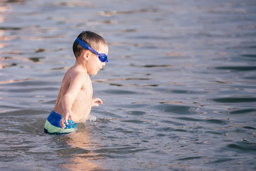 Happy child swimming in the sea