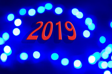 new year and Christmas celebration  concept of blue and white illumination and background surface with red numbers of "2019"